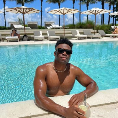 Photo of Caleb Castille while drinking an leamon water in swimming pool.